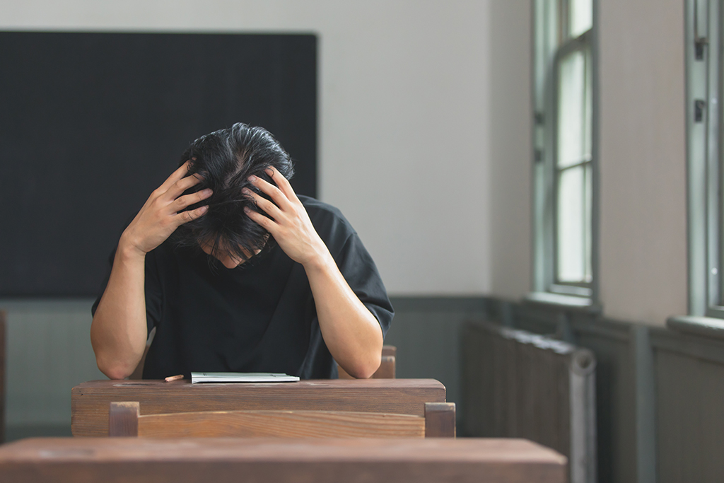 頭を抱えている